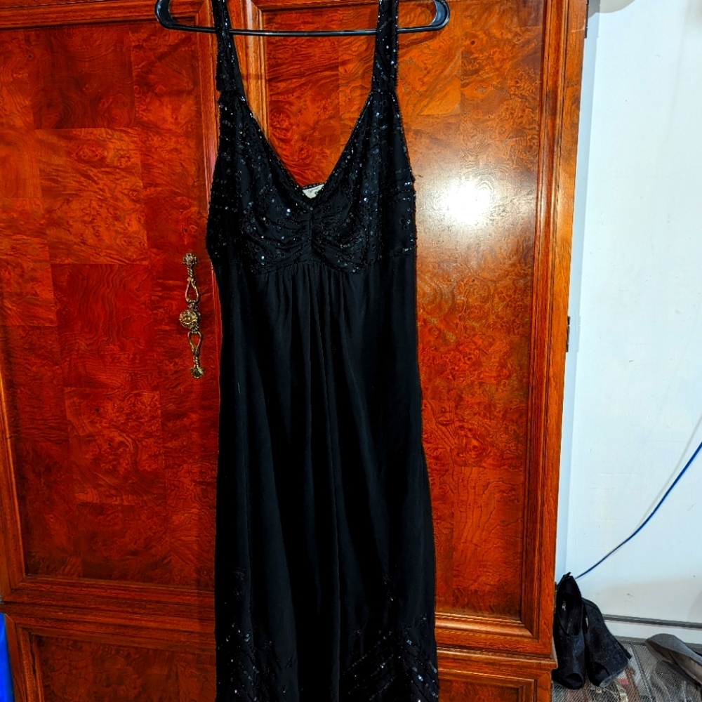A nice fancy looking black silky sequins dress sheer and sequins at the bottom h